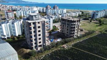 GÜZELYURT DENİZ MANZARALI 3+1 TEMELDEN DAİRELER