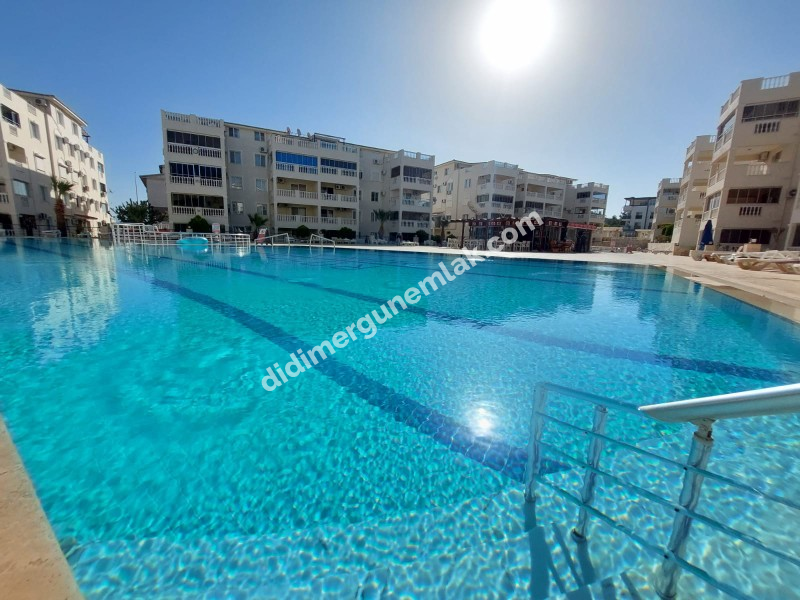 DİDİM ÇAMLIK MAHALLESİ’NDE,EŞYALI, HAVUZ CEPHELİ, DENİZE YÜRÜME MESAFESİNDE SATILIK 2+1 DAİRE