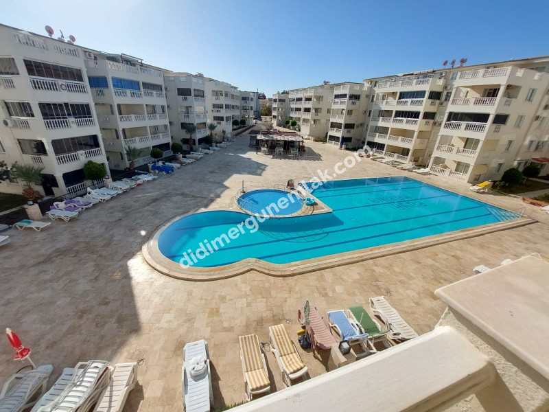 DİDİM ÇAMLIK MAHALLESİ’NDE,EŞYALI, HAVUZ CEPHELİ, DENİZE YÜRÜME MESAFESİNDE SATILIK 2+1 DAİRE