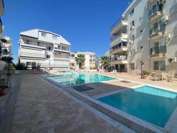 ALTINKUM MAHALLESİNDE DENİZE YÜRÜME MESAFESİNDE,SİTE İÇİNDE,HAVUZLU EŞYALI,,GENİŞ BALKONLU 2+1 SATILIK DAİRE