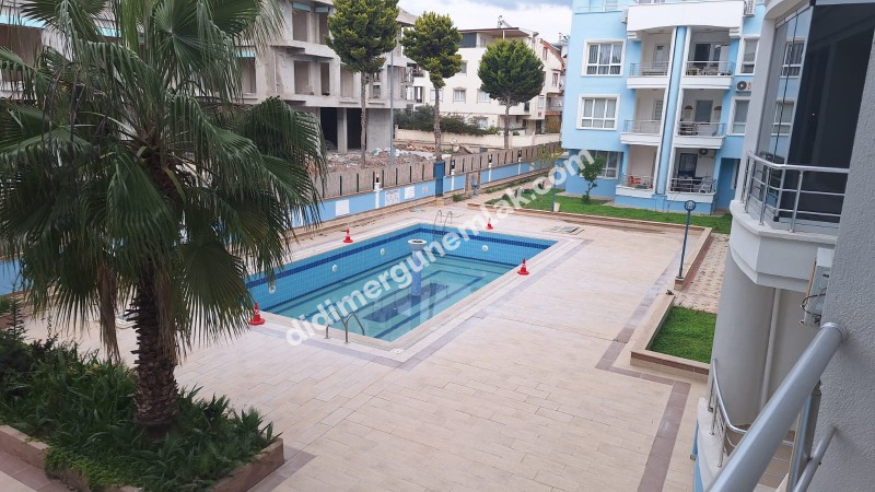  DİDİM EFELER MAHALLESİ'NDE GÜVENLİKLİ SİTE İÇERİSİNDE HAVUZLU 2+1 AÇIK MUTFAKLI SATILIK DAİRE