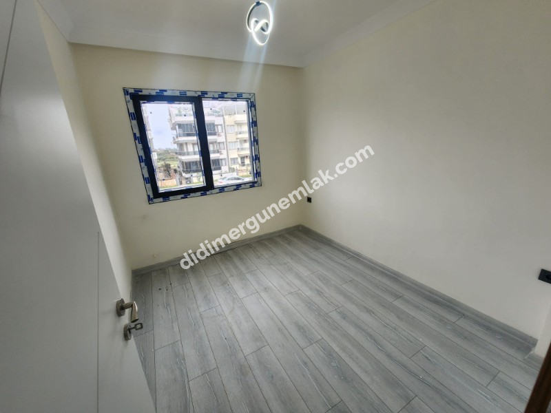 DİDİM EFELER MAHALLESİNDE STADYUM BÖLGESİNDE DENİZE YÜRÜME MESAFESİNDE SIFIR 2+1 SARTILIK DAİRE